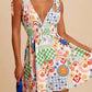 Daverri V-neck smocked waist mini dress with vibrant patchwork print