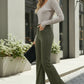 Woman in gray ribbed top and high-waist olive corduroy pants