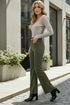 Woman in gray ribbed top and high-waist olive corduroy pants