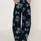 Printed wide-leg jeans in black denim with white floral pattern