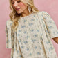 Cream-colored SO ME floral print blouse with lace trim and flutter sleeves