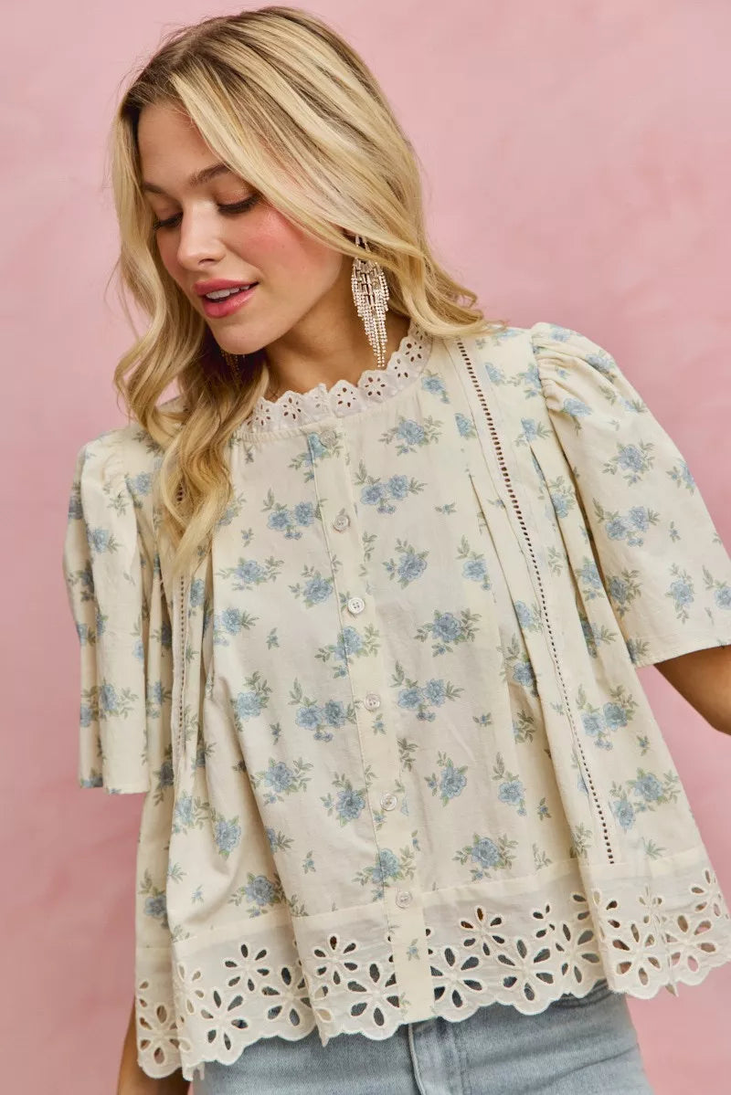 Cream-colored SO ME floral print blouse with lace trim and flutter sleeves
