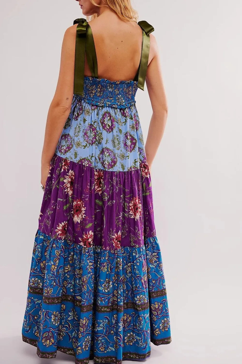 Floral tiered maxi dress with blue purple floral pattern and green straps