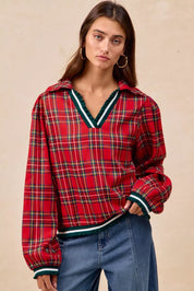 Red plaid collared hoodie with green white trim and ruffles