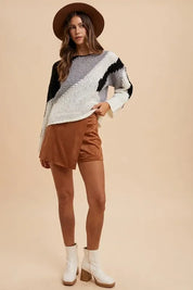 Brown leather shorts, white heeled boots, and Annie Wear Color Block Drop Shoulder Sweater
