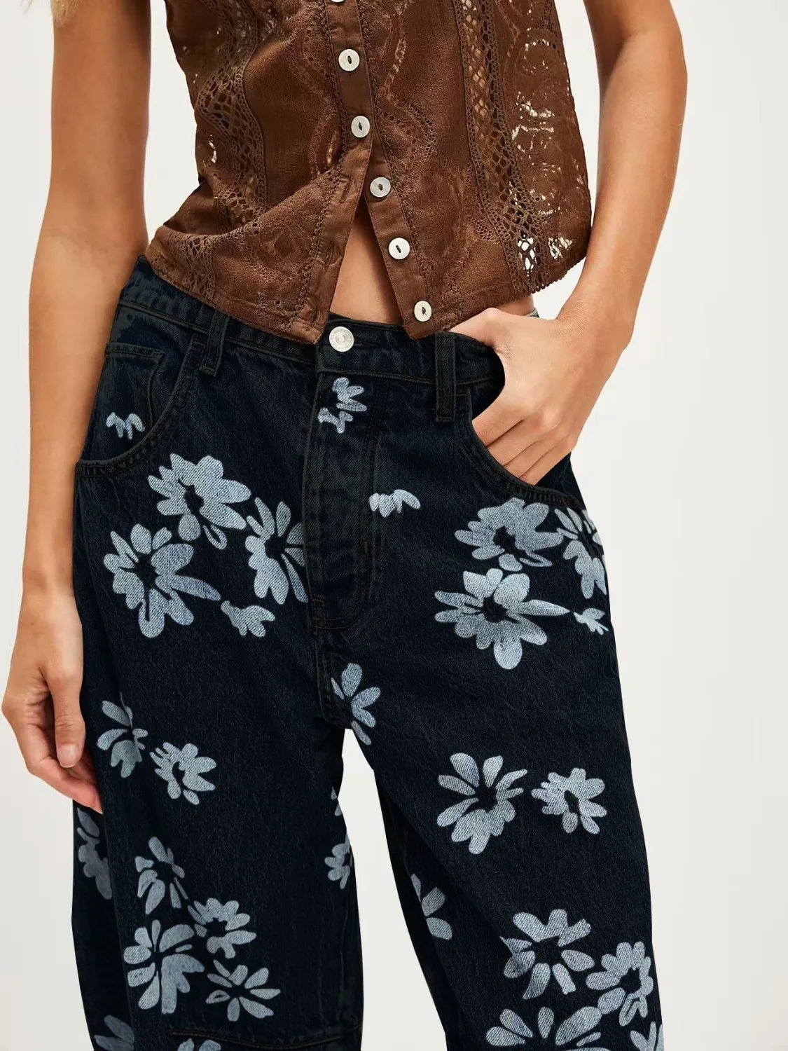 Printed wide leg jeans in black denim with silver and white floral pattern