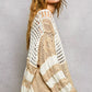 Beige and white chunky knit top with crochet openwork and color-blocked stripes