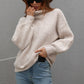 Cream-colored ribbed knit turtleneck sweater with balloon sleeves by Daverri