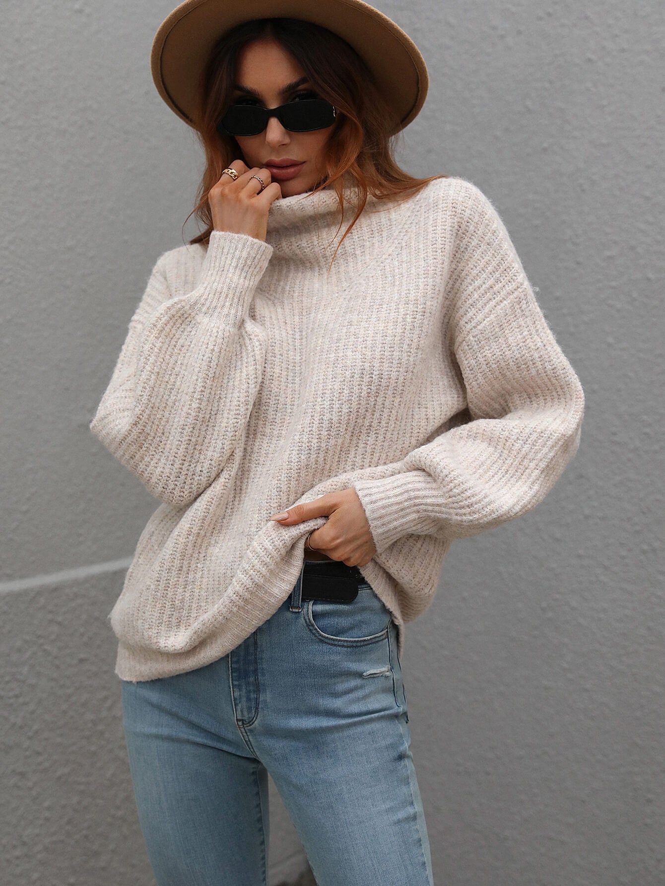 Cream-colored ribbed knit turtleneck sweater with balloon sleeves by Daverri