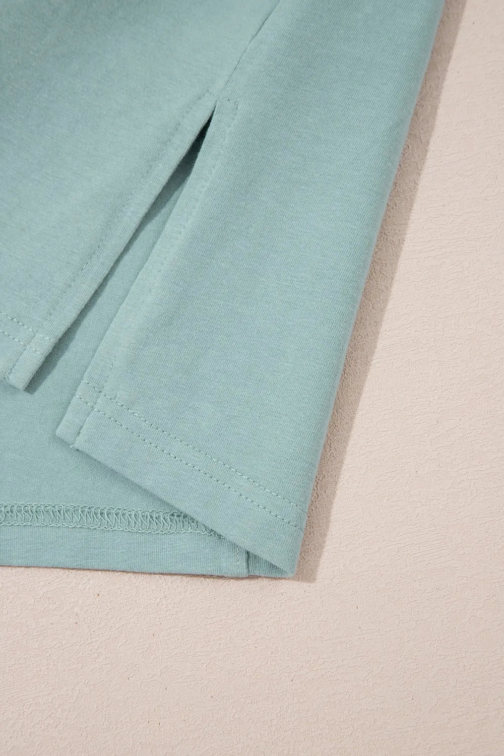 Frayed denim star patched oversize t-shirt in soft mint green knit with ribbed texture and stitched seams