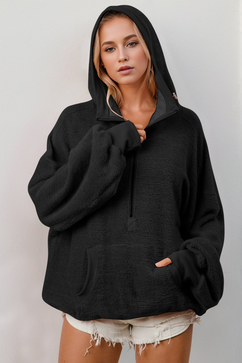 Black oversized hoodie with textured fabric, ribbed cuffs, kangaroo pocket