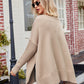 Beige knit V-neck poncho sweater with slit seams, ribbed cuffs, hem, relaxed fit