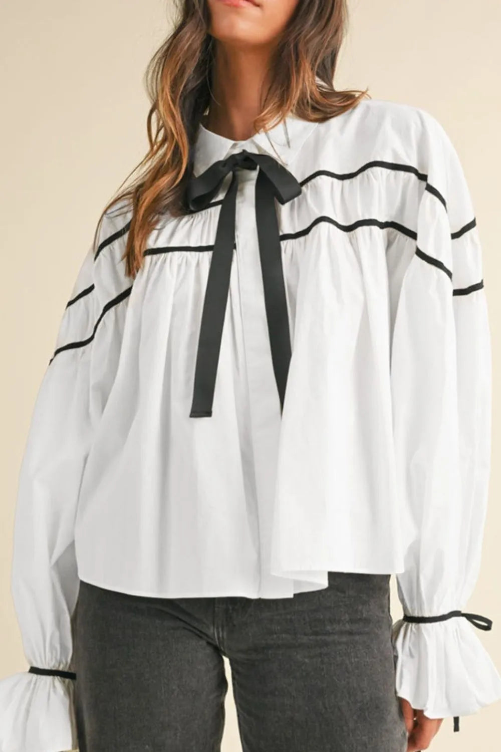 White ribbon bowtie collared blouse with black ruffle trim