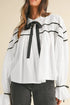 White ribbon bowtie collared blouse with black ruffle trim