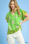 Vibrant green Umgee Boho Bloom Border Top with floral skull motifs