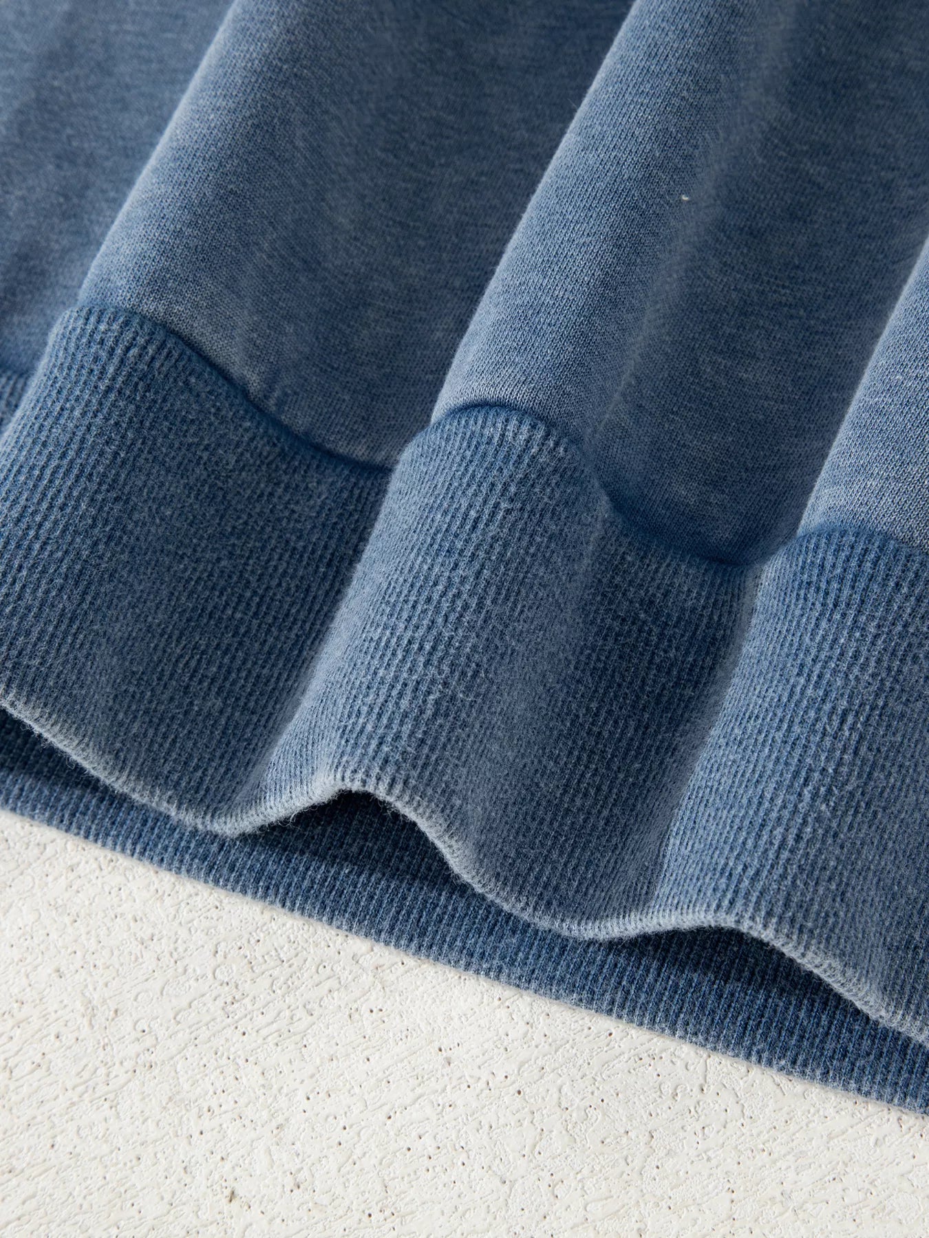 Soft blue knit baggy sweatshirt with ribbed cuffs and lace patchwork detail