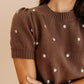 Brown ribbed polka dot knit top with short puffed sleeves