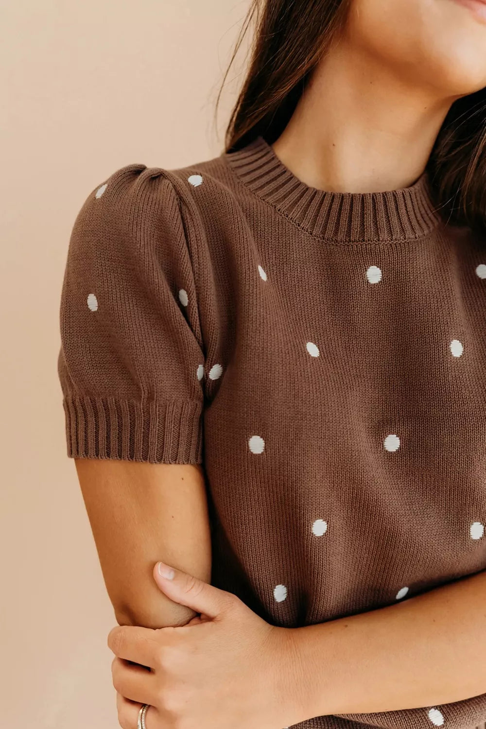 Brown ribbed polka dot knit top with short puffed sleeves