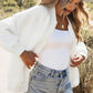 White oversized denim jacket with frayed hem and ribbed cuffs