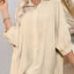 Beige womens oversized 3/4 sleeve button-down shirt with rolled cuffs