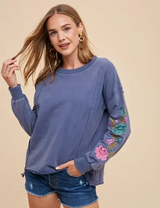 Blue floral embroidered Annie Wear French terry sweatshirt with denim shorts and gold hoops