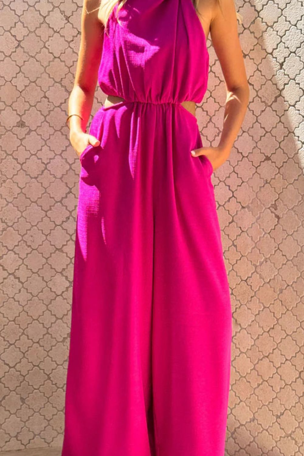 Vibrant fuchsia cutout sleeveless halter-neck wide-leg jumpsuit, cinched waist