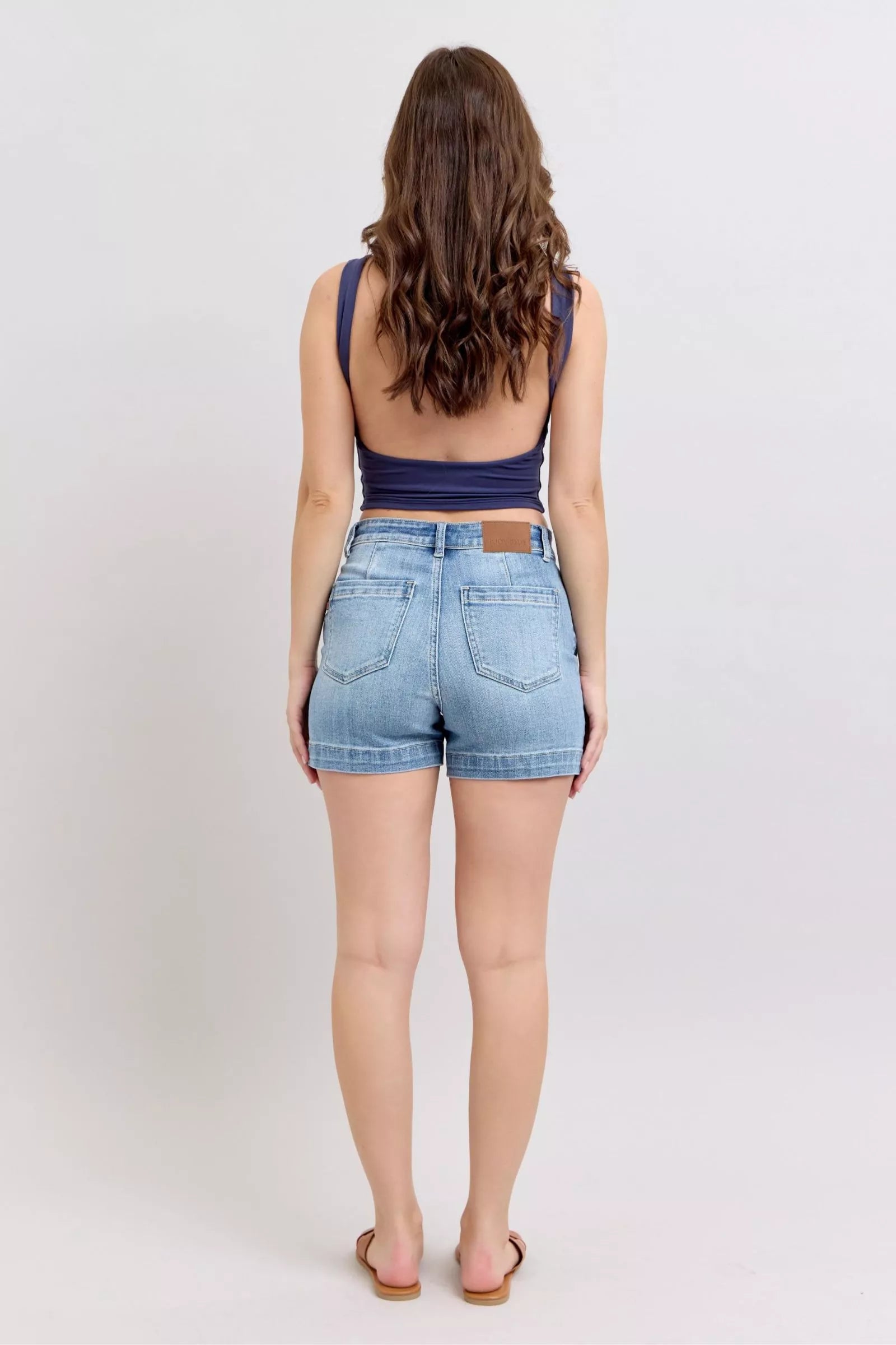 Judy Blue mid-rise light-wash denim shorts with 5-pocket design, leather patch