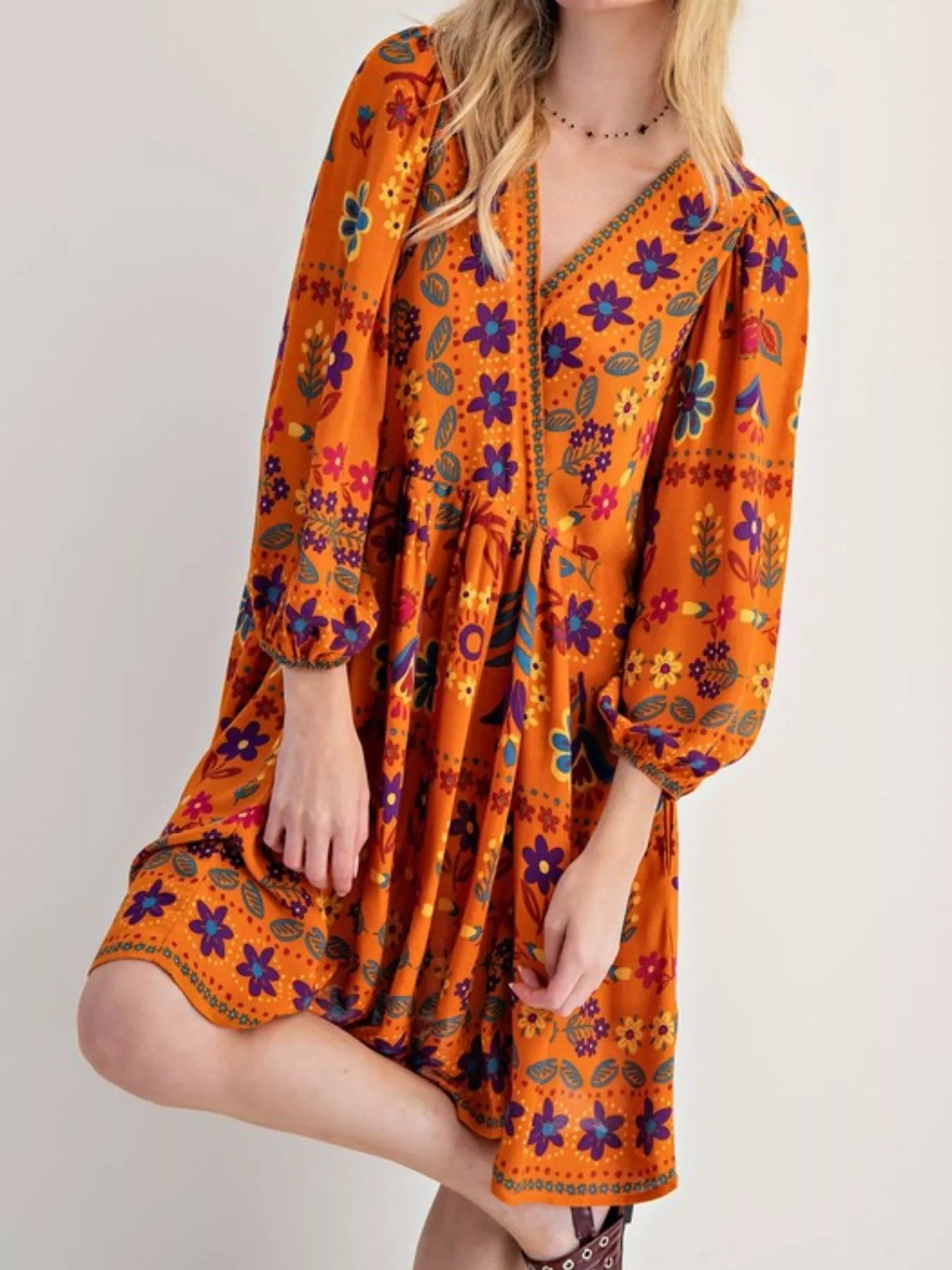 Vibrant orange bohemian floral print long sleeve mini dress with v-neckline