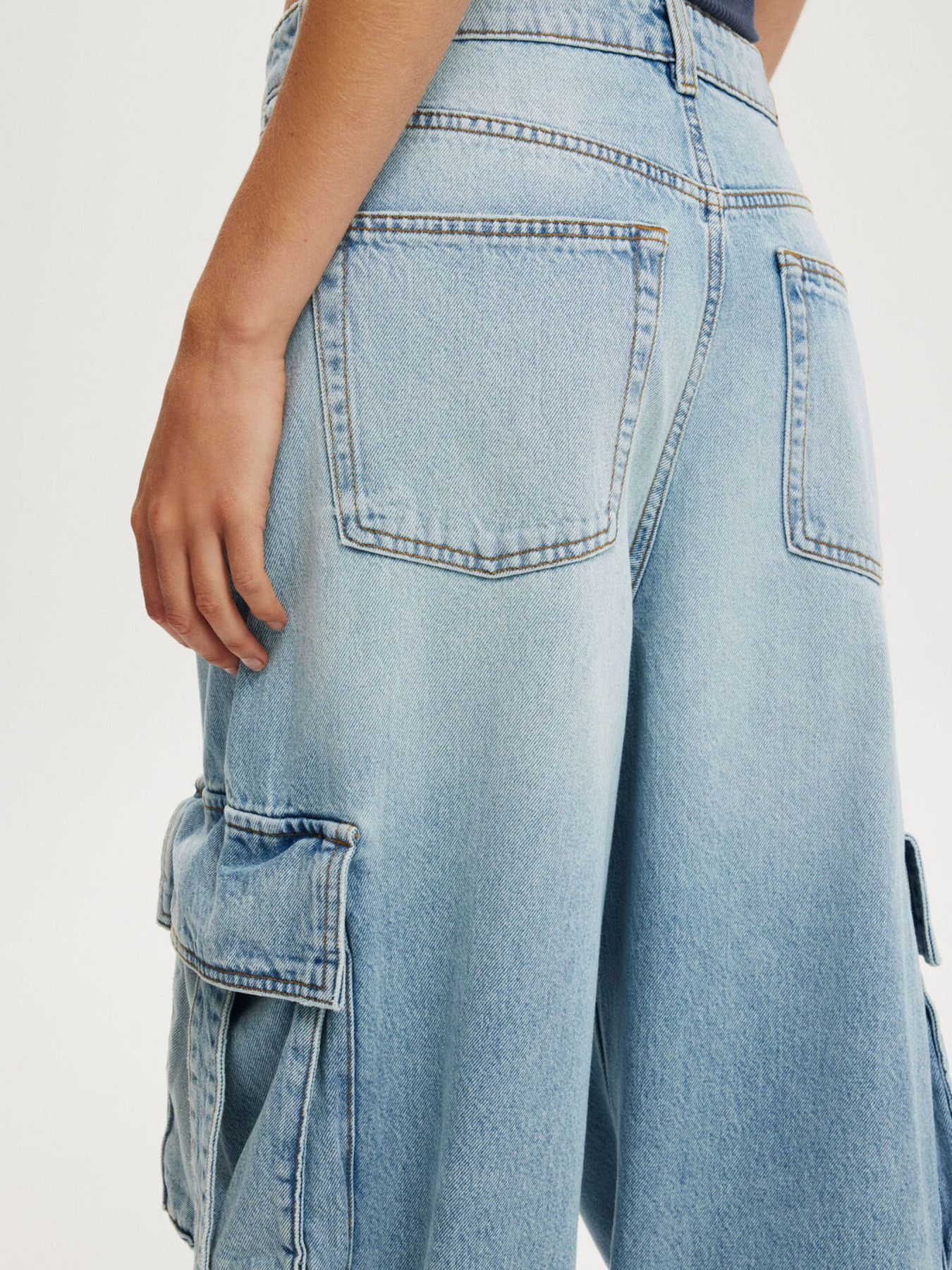 Vintage Wash Wide Leg Cargo Jeans in light-wash denim with visible stitching
