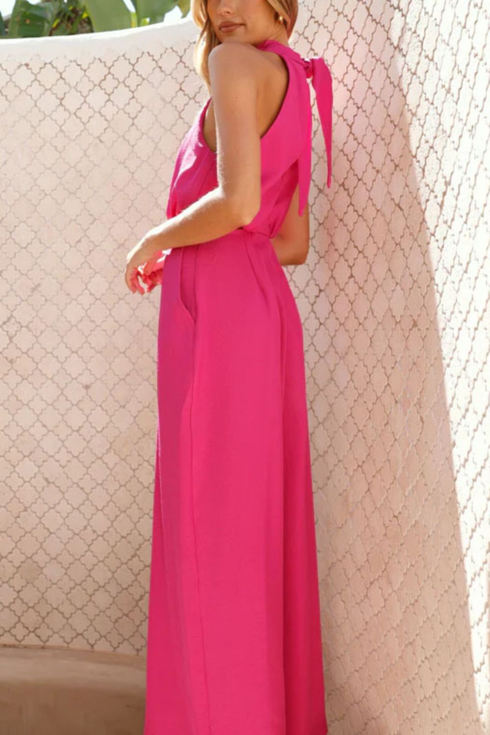 Vibrant fuchsia cutout halter-neck wide-leg jumpsuit with back tie and pockets