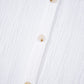 Three translucent beige buttons on women’s lace sleeve cotton shirt