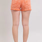 Back view of Judy Blue Peach mid-rise distressed denim shorts with frayed hem