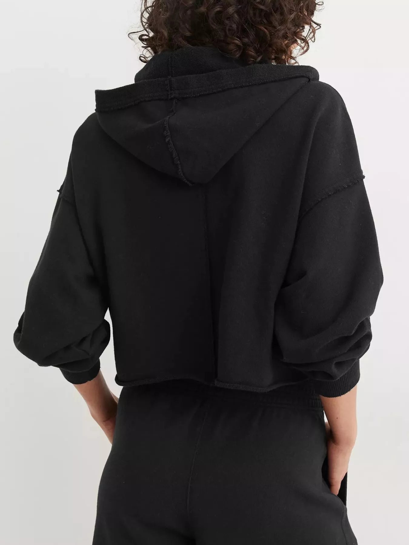 Black Exposed Seam Dropped Shoulder Hoodie with cropped relaxed fit and ribbed cuffs