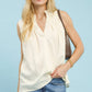 Umgee sleeveless textured split neck top in cream with v-neck and pleats