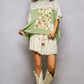 Woman in POL Sage Floral Patchwork Lace Blouse and cream cowboy boots