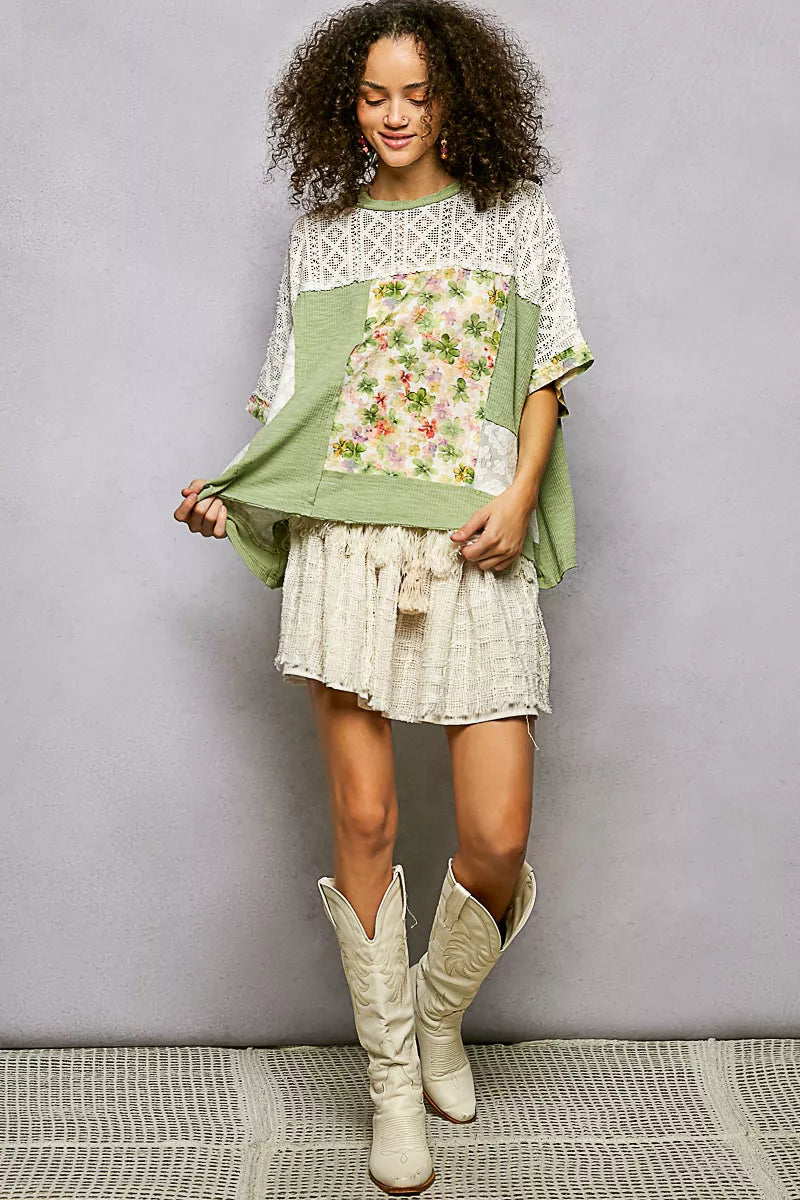 Woman in POL Sage Floral Patchwork Lace Blouse and cream cowboy boots
