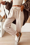 Beige drawstring loose fit pants with eyelet embroidery pockets