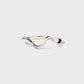 Silver ring with a wavy design on a white background