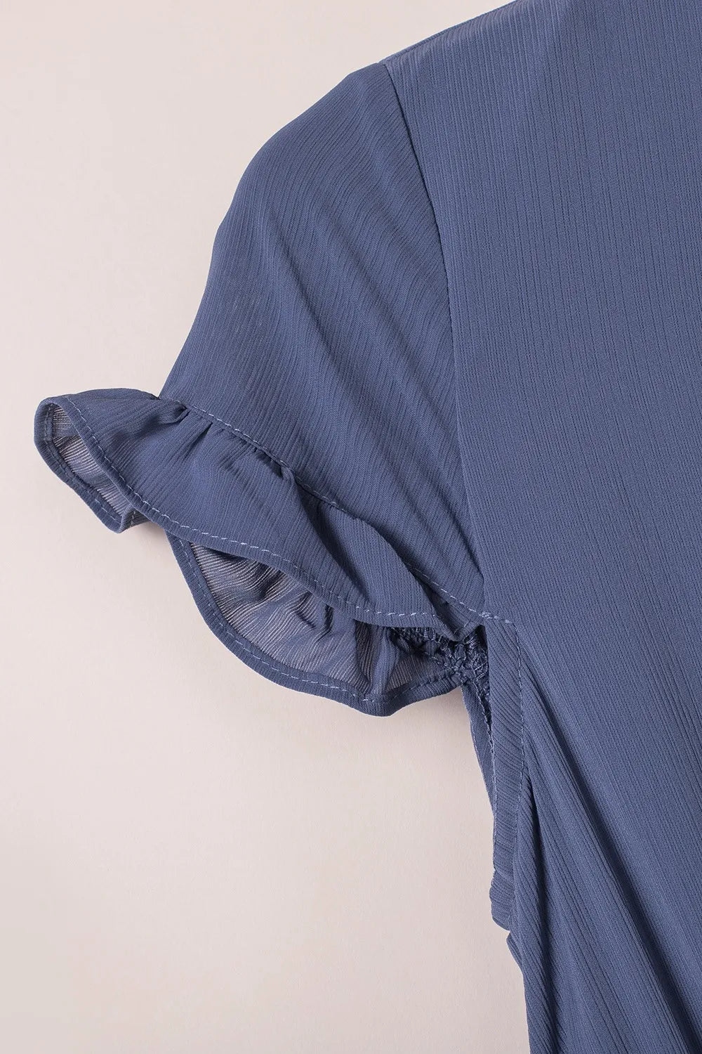 Navy blue tie-front mini dress with ruffled short sleeves and smocked waist