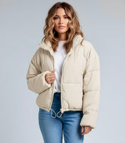 Beige puffer jacket with fur-lined hood and zipper closure
