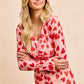 Pink long-sleeved BiBi button-down shirt with red heart print and ruched front