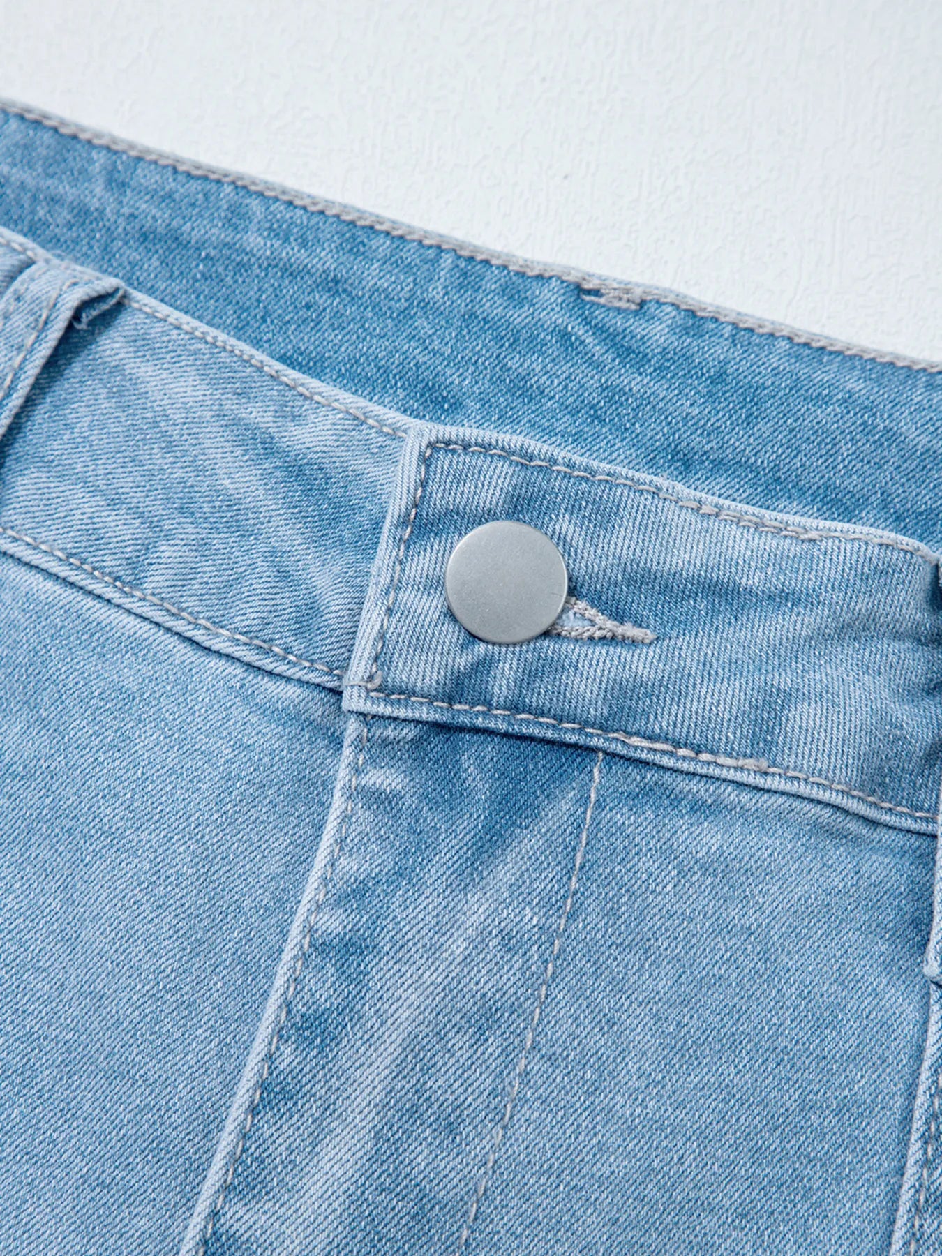 Light blue high rise barrel relaxed jeans with silver button and pocket detail