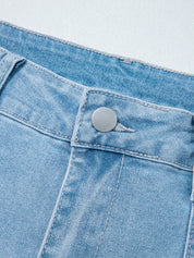 Light blue high rise barrel relaxed jeans with silver button and pocket detail