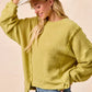 Olive-green BiBi Boucle rib knit sweater with ruffled uneven hem
