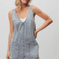 BiBi Patch vintage washed denim shortall with light-wash overall shorts, V-neck, and front pockets