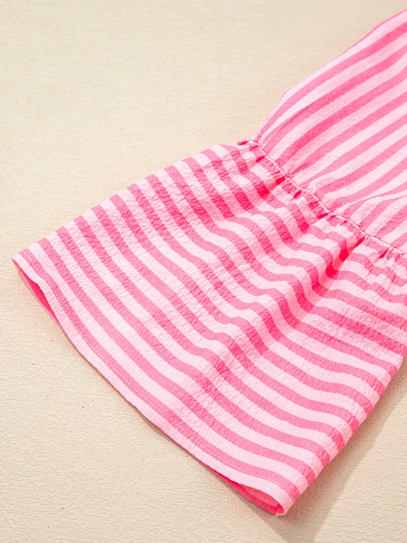 Pink and white striped flowy mini dress with flare sleeves and gathered waistband