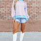 Pastel pink and light blue striped high-low long-sleeve sweatshirt with solid blue hem