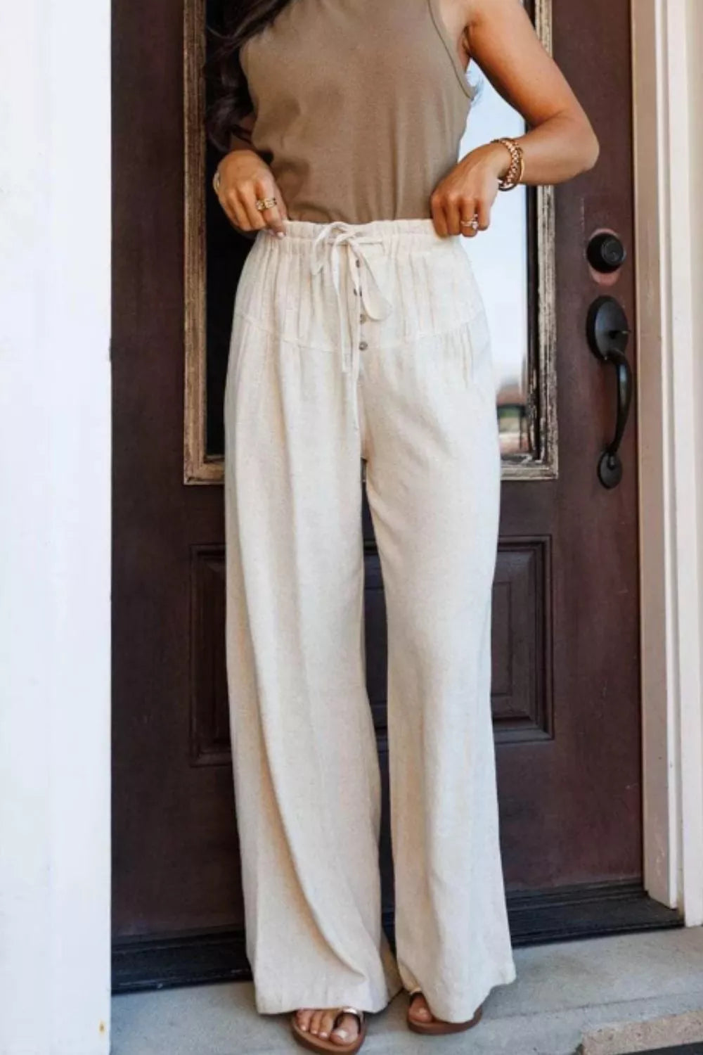 Beige high-waisted wide-leg drawstring pants with button details