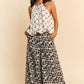 Woman in Davi & Dani ribbon checker printed halter neck blouse with leopard pants