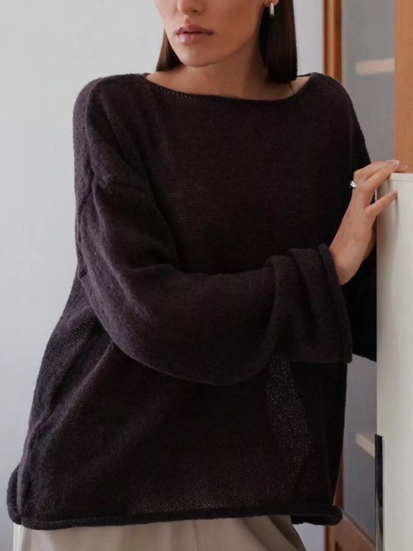 Boat neck dropped shoulder sweater in soft dark charcoal knit with loose fit and wide sleeves